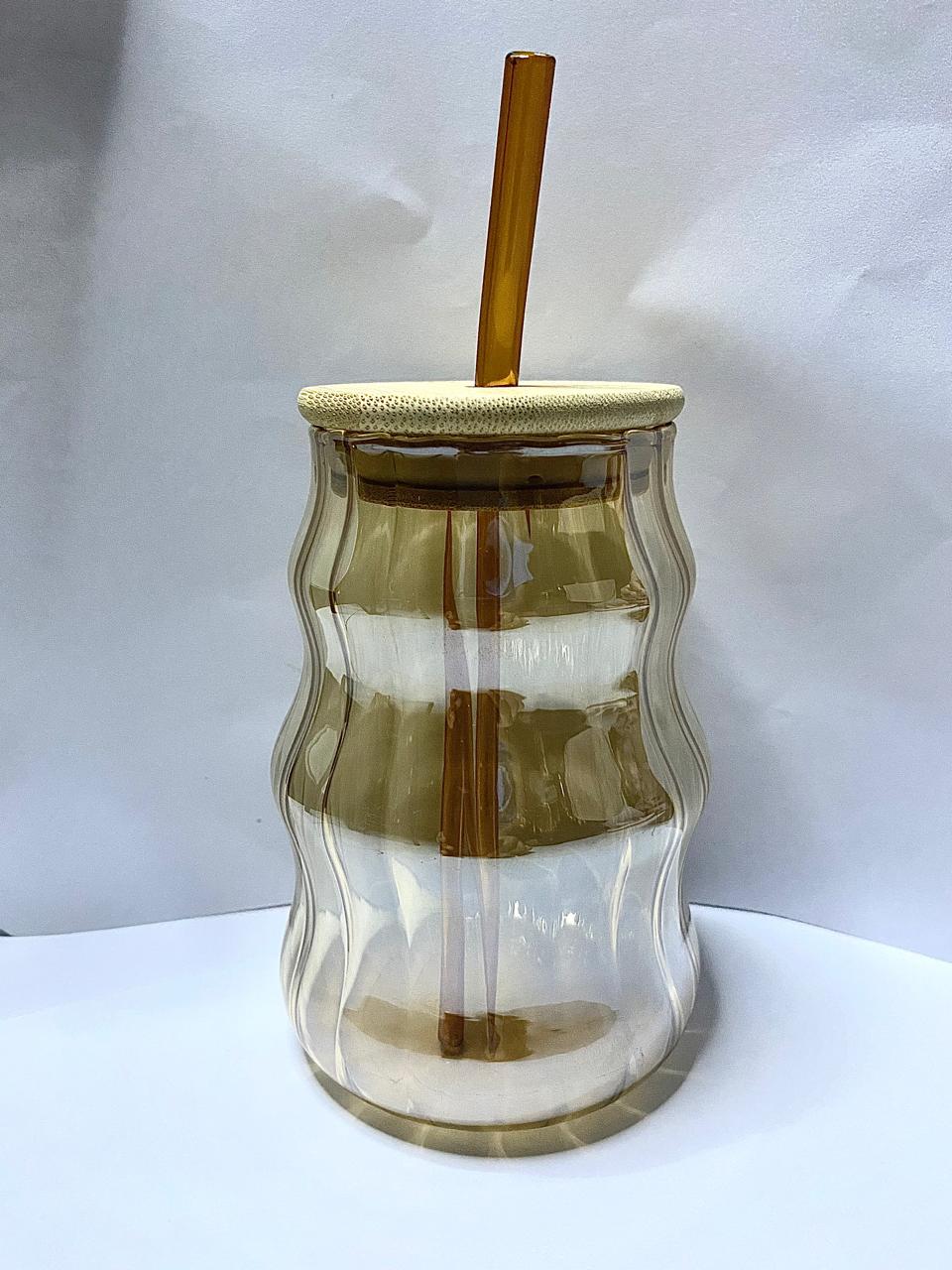 Amber wave glass tumbler with bamboo lid and straw.