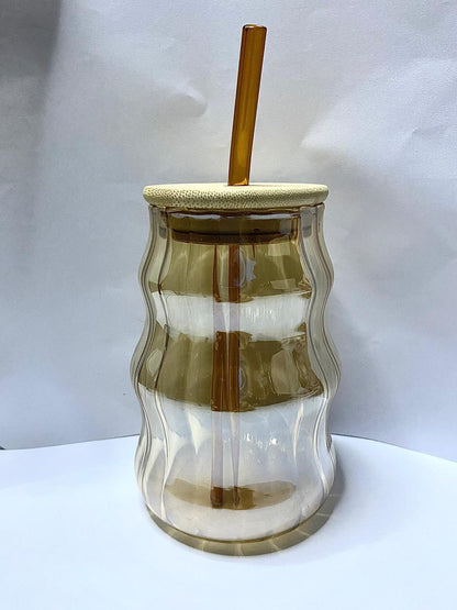 Amber wave glass tumbler with bamboo lid and straw.