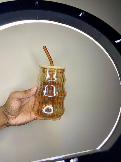 Amber wave glass tumbler with bamboo lid and straw.